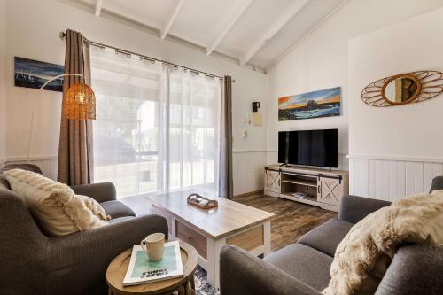a living room with two couches and a tv at Bay Village Dunsborough in Dunsborough
