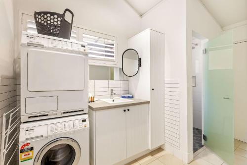 a white laundry room with a washer and dryer at Bay Village Dunsborough in Dunsborough