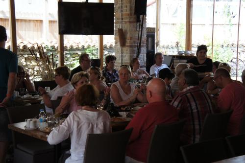 a group of people sitting at tables in a restaurant at Ormana Active Butik Otel in İbradı