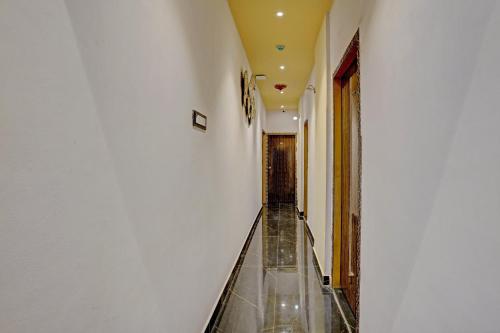 an empty corridor of a building with a glass floor at Hotel O Golden Suites in Turambhe