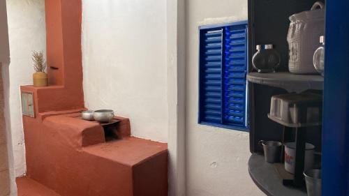 a corner of a room with a blue window at Fazenda Brasileiro in Passos