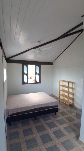 a bedroom with a large bed in a room at Casa do Sargento in Saquarema