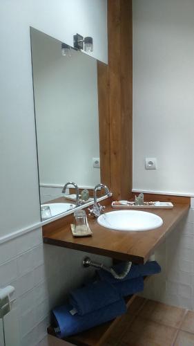 a bathroom with a sink and a mirror at Casa Fidela in Lomeña