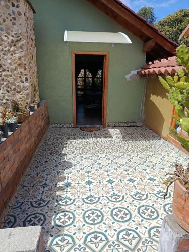 a house with a tiled courtyard with a door at Moss in Colombia