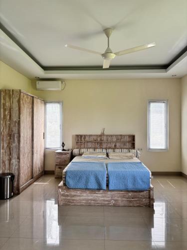 a bedroom with a bed and a ceiling fan at Private Studio Near Kedungu Beach Cozy & Affordable in Tanah Lot
