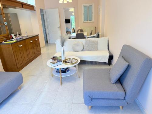 a living room with a couch and a table at Zeus Beach Condo in Vernardhaíika