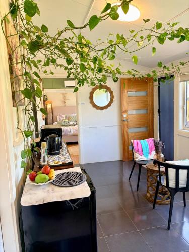 a kitchen with a counter top with fruits on a table at Mystic Gardens with private entrance and bathroom in Wentworthville