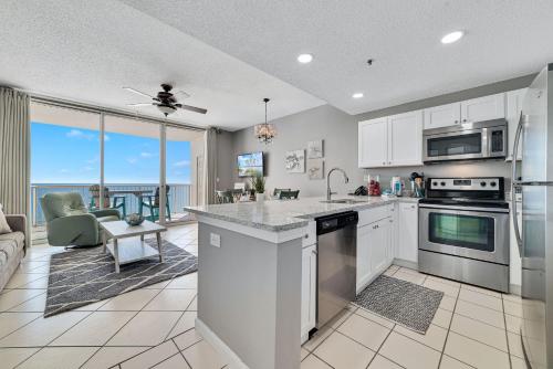 a kitchen and living room with a view of the ocean at Catalina 902-Updated Beachfront Condo with Amazing Views-Full Service Resort in Gulf Shores