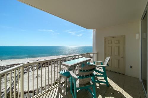 a balcony with a table and chairs and the beach at Catalina 902-Updated Beachfront Condo with Amazing Views-Full Service Resort in Gulf Shores