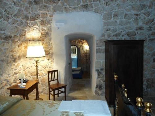 A bed or beds in a room at Tenuta Pigliano Hotel