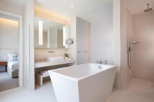 a white bathroom with a tub and a sink at JW Marriott Venice Resort & Spa in Venice