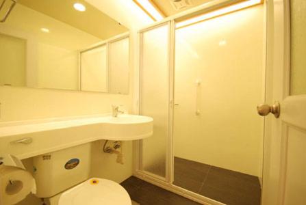 a bathroom with a toilet and a sink and a shower at Natural Residence B&B in Taian