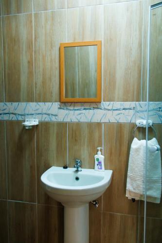a bathroom with a sink and a mirror at Selamu Self Catering in Walvis Bay