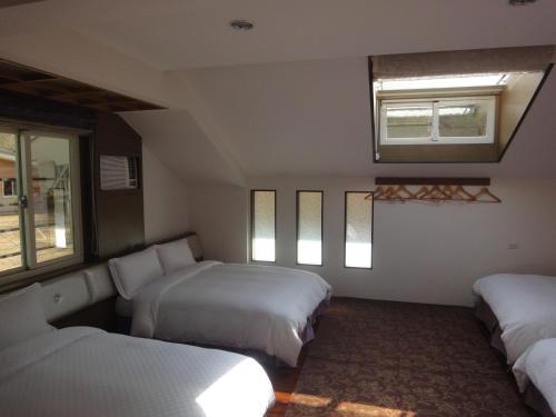 a hotel room with two beds and a window at Natural Residence B&B in Taian