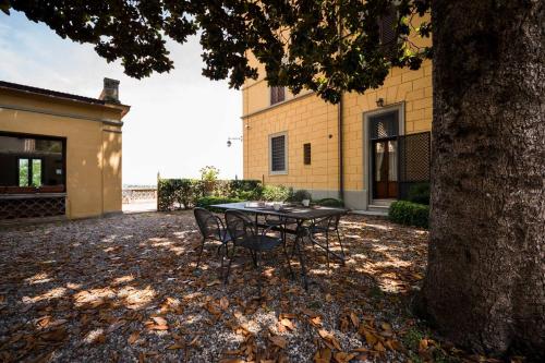 a table and chairs sitting in front of a house at Villa Socini in Siena