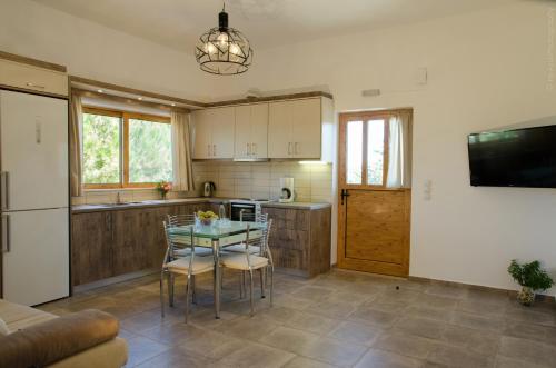 a kitchen with a table and chairs in a kitchen at Villa Sunrise in Epáno Kefalás