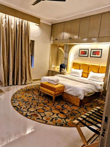 a bedroom with a large bed and a rug at Vijay Mansion Pratap Enclave in Jaipur