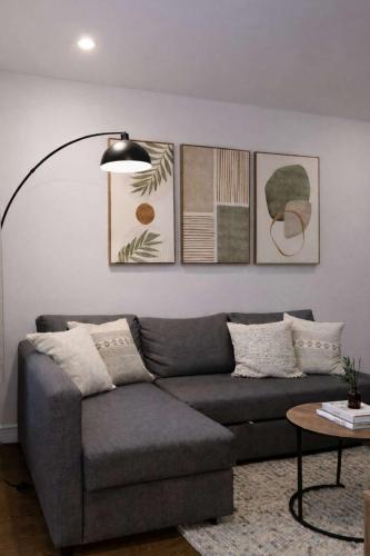 a living room with a couch and some pictures on the wall at Hip NYC Hideaway in Lively East Village in New York