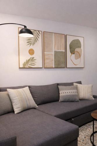 a living room with a couch and some pictures on the wall at Hip NYC Hideaway in Lively East Village in New York