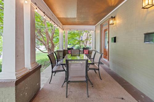 a porch with a table and chairs on it at Annesdale #1 - Spacious & Central 3BR in Midtown! in Memphis