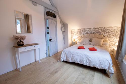 a bedroom with a large white bed and a table at Villa Alexandre III in Dijon