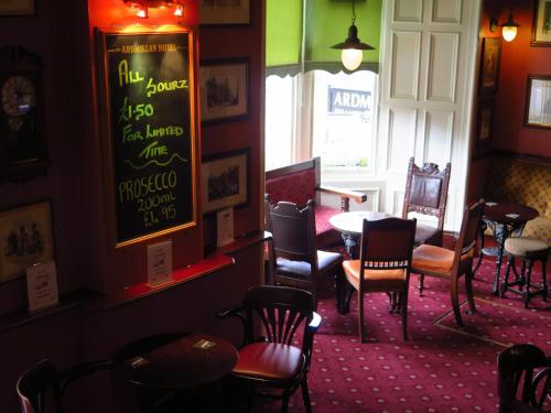 a dining room with chairs and a table and a window at Ardmillan Hotel in Edinburgh