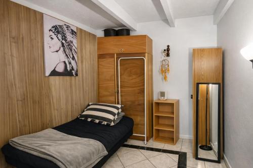 a bedroom with a bed and a wooden cabinet at Affordable & cosy, close to train station, CBD & Airport in Perth