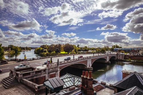 a bridge over a river with cars on it at The Mitre, Hampton Court in Kingston upon Thames