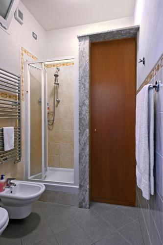 a bathroom with a shower and a toilet and a sink at Le Terrazze Appartamenti Vacanze in Sanremo