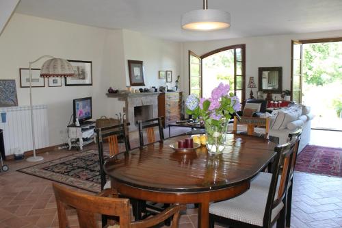 a dining room and living room with a table and chairs at Donna Etrusca in Sutri