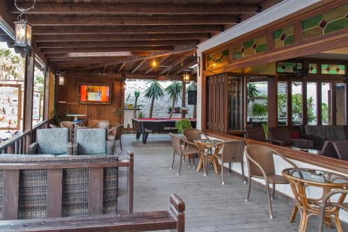 a patio with tables and chairs and a pool table at Rio Hotel in Kardamaina