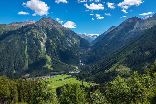 a view of a valley in the mountains at Hotel CENTRAL Bar & Restaurant in Gerlos