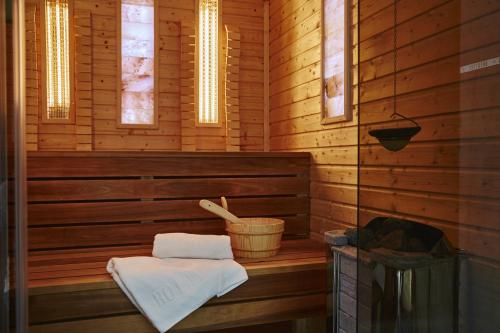 a wooden sauna with a towel and a basket at Botrytis Borhotel in Mád