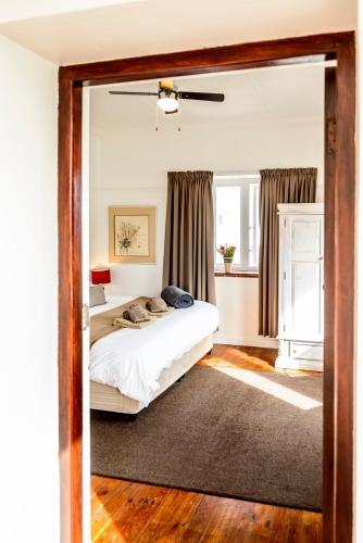 a bedroom with a bed and a large mirror at The Muize in Muizenberg