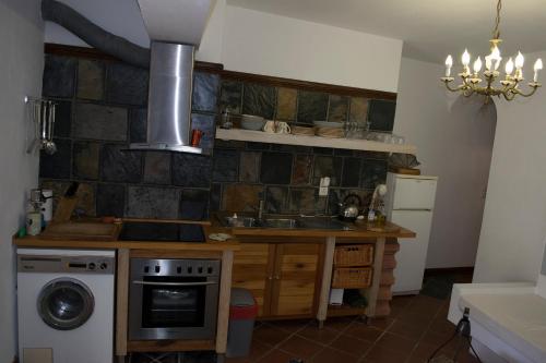 a kitchen with a sink and a stove at Roditses Beach Sea Front Apartments in Samos