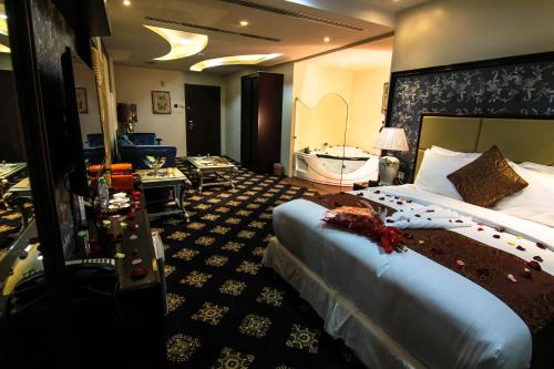 a hotel room with a large bed and a bathroom at Rest Night Serviced Apartments- AlHamra in Riyadh