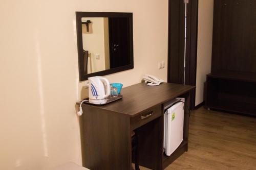 a bathroom with a vanity with a sink and a mirror at Sem Uglov in Tiraspol