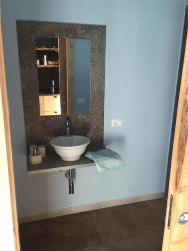 a bathroom with a sink and a mirror at Villa Atena Baia Cornino in Custonaci