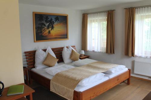 a bedroom with a large bed with white pillows at Bauernhof Familie Knoblechner in Nussdorf am Attersee