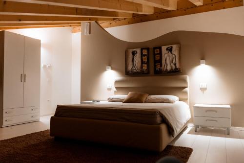 a bedroom with a bed and two pictures on the wall at Ca' del Sile in Morgano