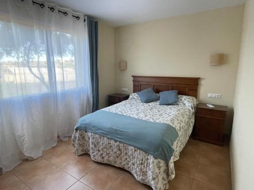 a bedroom with a bed and a large window at Can Chus Cala Anguila in Cala Mendia