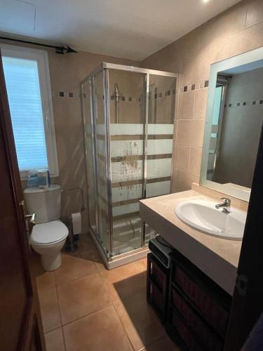 a bathroom with a shower and a toilet and a sink at Can Chus Cala Anguila in Cala Mendia
