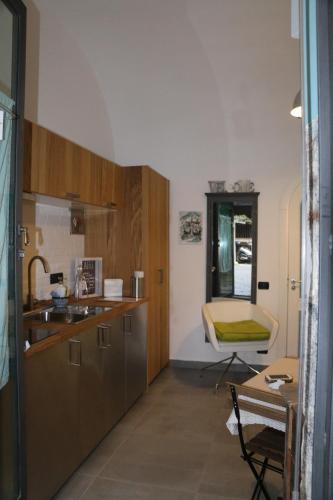 a kitchen with a sink and a table with a chair at The Lodge in Naples
