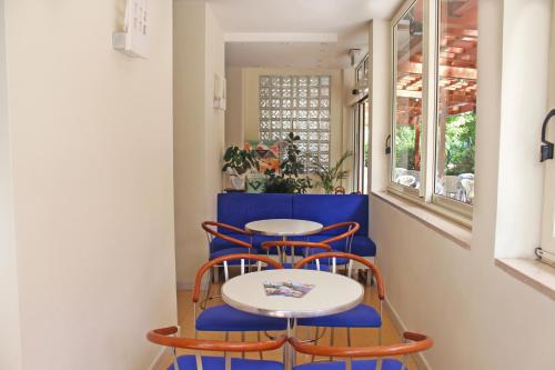 a couple of tables and chairs in a room at Hotel Metron in Cesenatico
