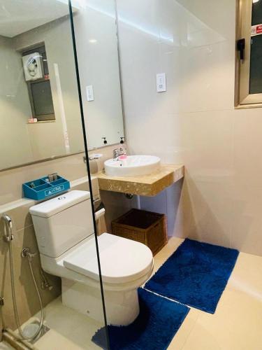 a bathroom with a toilet and a sink at Atrium - ICONIC APARTMENT in Sri Jayewardenepura Kotte