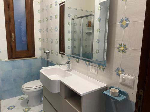 a bathroom with a sink and a toilet at Villetta Cala Rotonda in Favignana