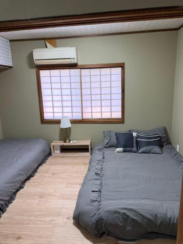a bedroom with two beds and a window at star in Osaka