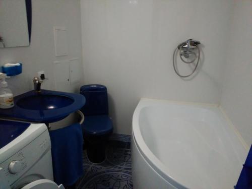 a small bathroom with a toilet and a sink at Apartments Morskoy Zakat in Zelenogradsk
