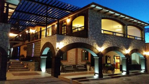 a large building with arches and lights on it at Hotel Villa Bernal in Bernal