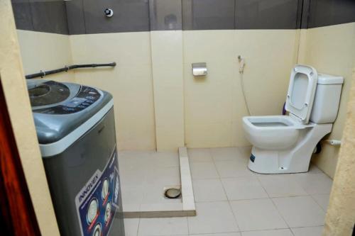 a small bathroom with a toilet and a sink at Jaffna Bungalow in Jaffna